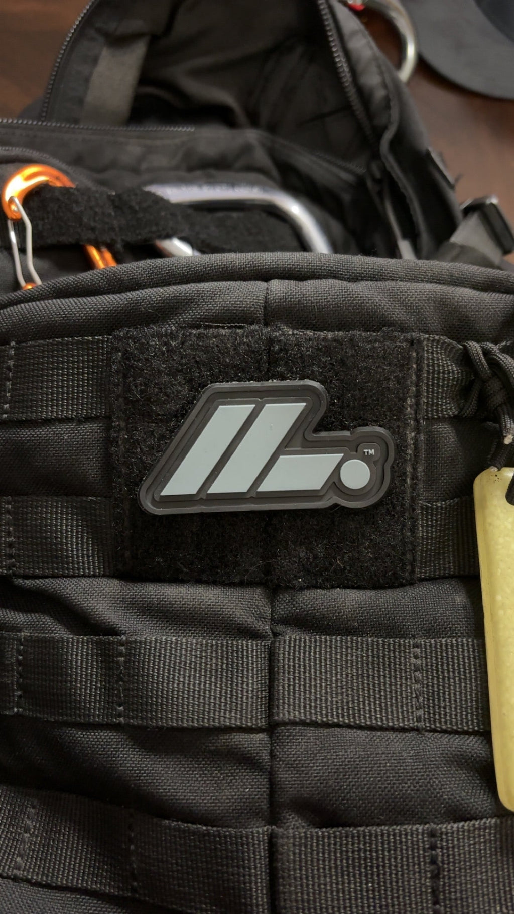 Actual LIFT. PVC patch on black backpack, close-up